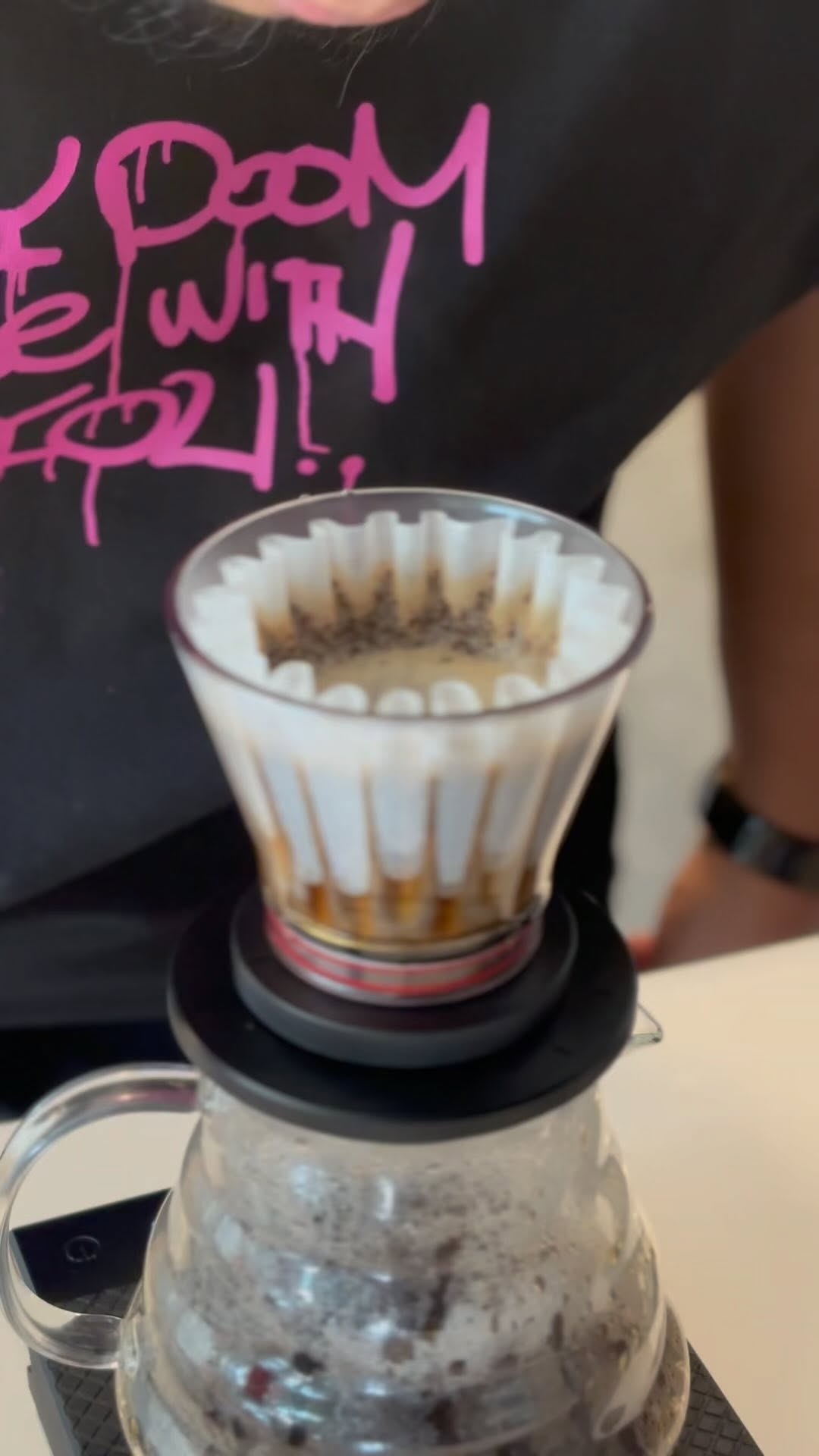 Barista performing pour-over coffee — Chemex style, close-up of filter and bloom